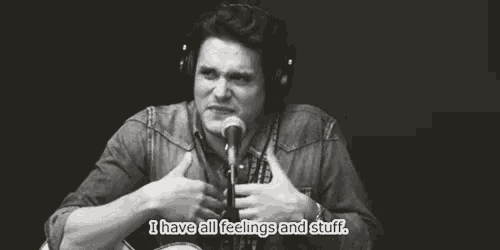 a man in headphones is talking into a microphone and says i have all feelings and stuff