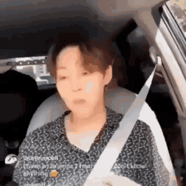 a man is sitting in a car with a seat belt on .