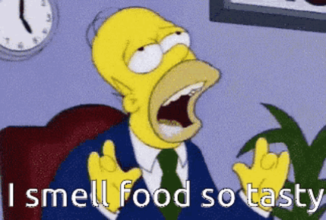 homer simpson is sitting in a chair and says i smell food so tasty
