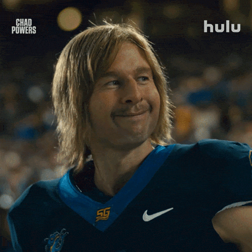 a man in a football uniform is smiling in front of a hulu ad