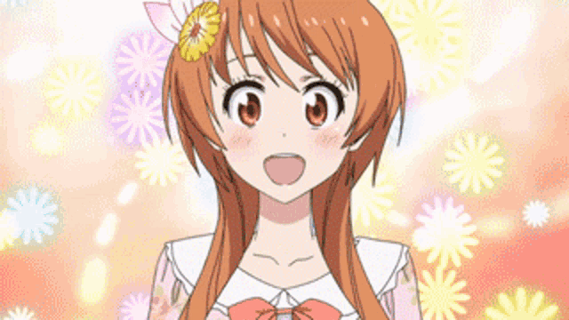 a girl with a flower in her hair is smiling in front of flowers