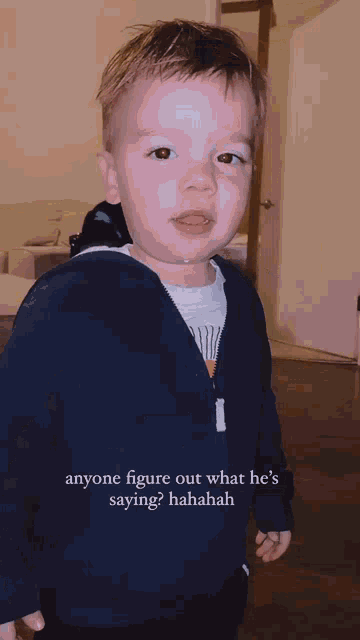 a little boy is standing in a living room with the caption anyone figure out what he 's saying ? hahahah