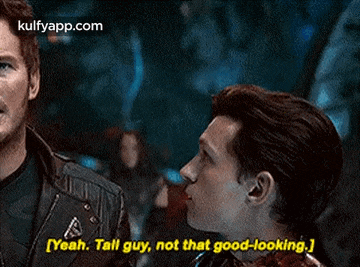 two men are talking to each other and one of them is saying `` yeah , tall guy , not that good looking . ''