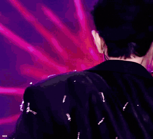 a close up of a man wearing earphones and a black jacket .