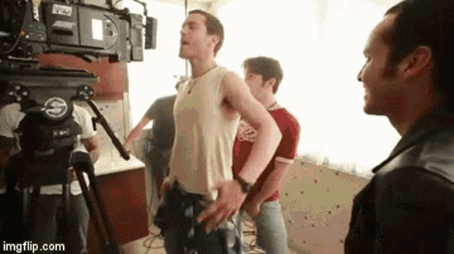 a group of men are standing in front of a camera with imgflip.com written on the bottom