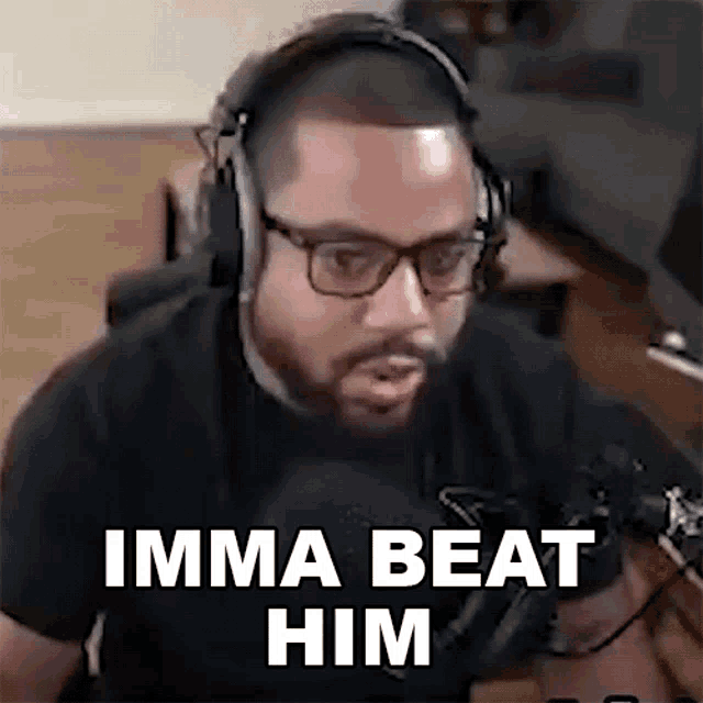 a man wearing headphones and glasses is talking into a microphone .