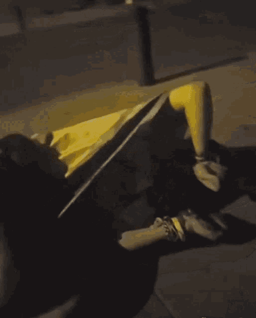 a person is laying on the ground with a yellow object in front of them