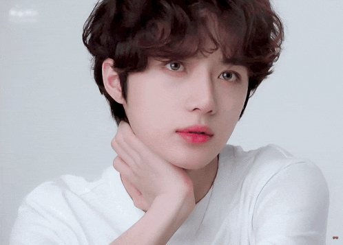 a close up of a person 's face with a white shirt