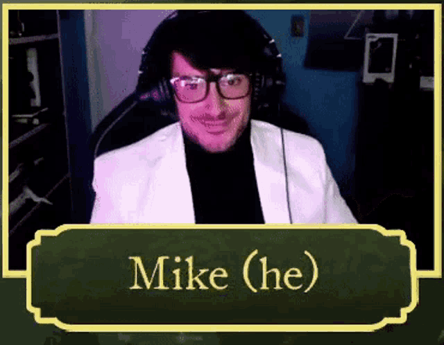 a man wearing glasses and headphones is sitting in a chair with the name mike written on the bottom .