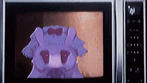 a microwave with a picture of a purple animal on it