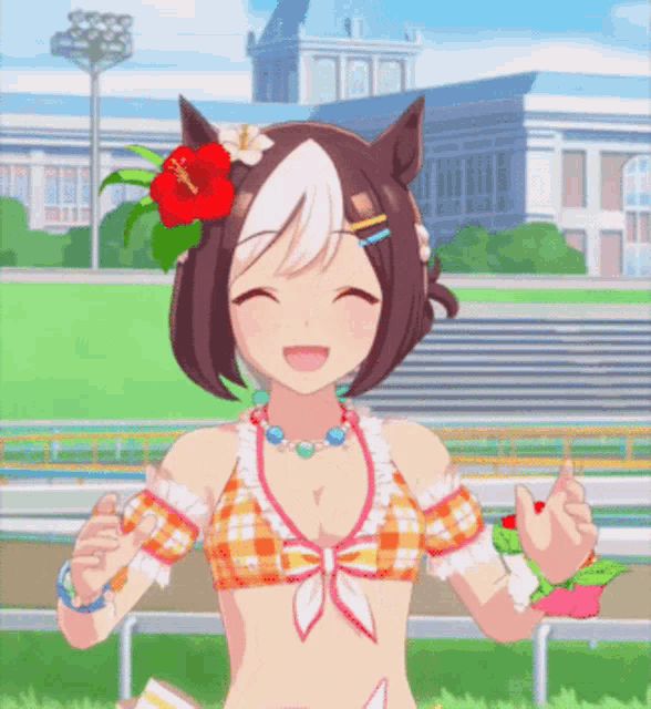 a girl with a flower in her hair is wearing a bikini