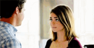 a man and a woman are looking at each other and talking .