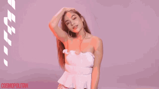 a woman in a white strapless top is holding her hair in front of the words the bra up
