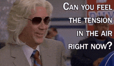 a man wearing sunglasses and a suit has the words can you feel the tension in the air right now