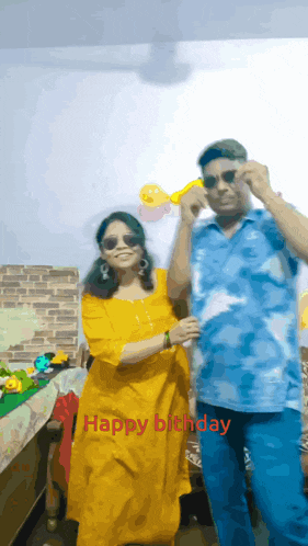 a man and a woman are posing for a picture with the words happy birthday on the bottom