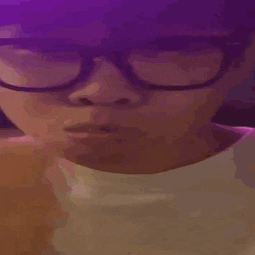a close up of a person 's face with a purple background