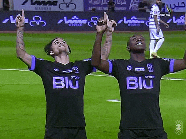 two soccer players wearing black jerseys that say blu