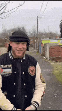 a man wearing a jacket that says palestine on the front