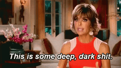 a woman in a red dress is sitting in a living room and says `` this is some deep , dark shit '' .