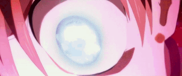 a close up of a person 's eye with a blue glow coming out of it .