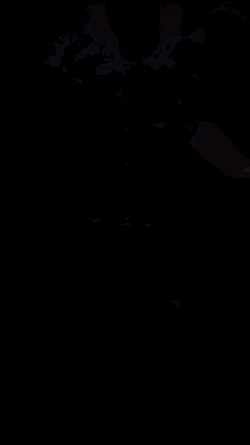 a person wearing a black oakley shirt and shorts