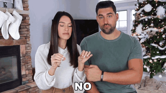 a man and a woman standing next to each other with the word no written on the bottom