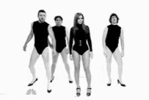 a group of people standing next to each other in black leotards and heels