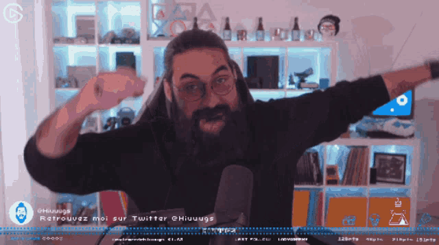 a man with a beard stands in front of a microphone