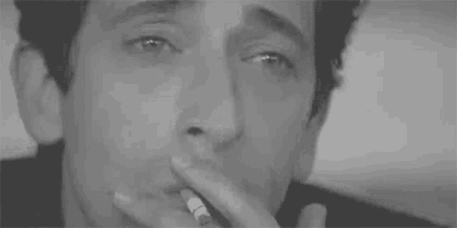 a black and white photo of a man 's face with tears running down his face .