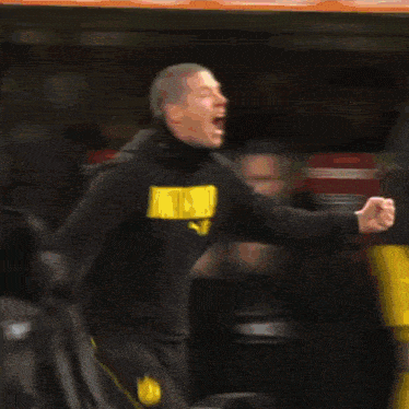 a man wearing a black sweatshirt that says dortmund on it