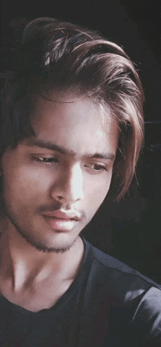 a close up of a man 's face with a black shirt on