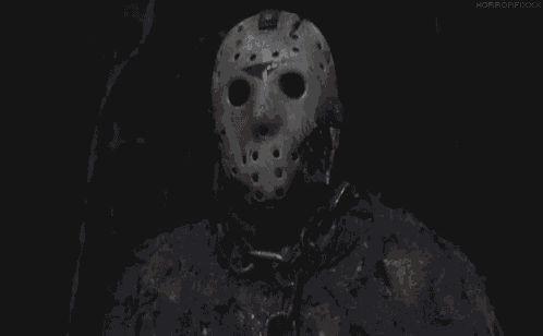 a close up of a person wearing a hockey mask and chains .
