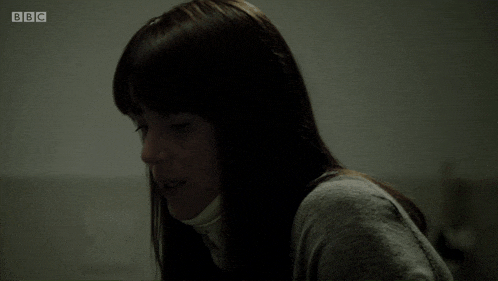a woman in a dark room with bbc written on the bottom right