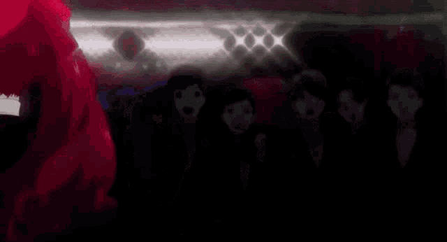 a man and a woman are dancing in a dark room .