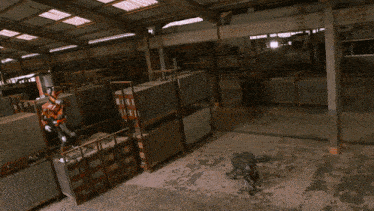 a man in a superhero costume is standing in a warehouse holding a large red object