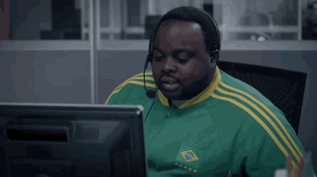 a man wearing headphones and a green and yellow shirt with a brazilian flag on it