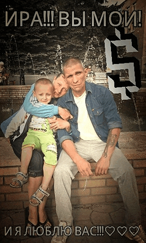 a man with a tattoo on his arm sits next to a woman holding a baby