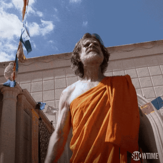 a man in an orange robe stands in front of a showtime logo