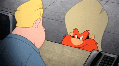 a cartoon character named looney tunes is talking to a man at a desk