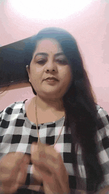 a woman wearing a black and white checkered shirt is holding something in her hands .