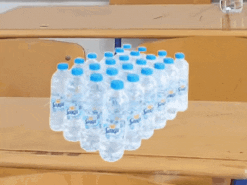 a bunch of bottles of soda sit on a desk