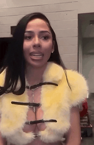 a woman wearing a fur coat with buckle straps on the front