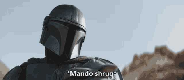 a man in a helmet says " mando shrug " in front of him