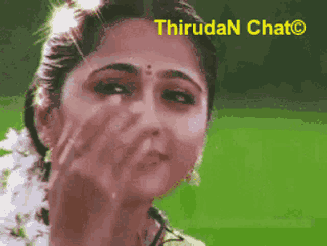 a close up of a woman 's face with a green background and the words thirudan chat on the bottom