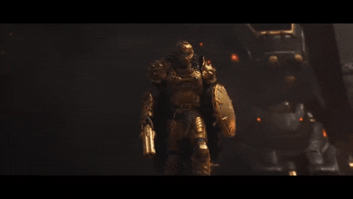a man in gold armor is holding a gun and a shield
