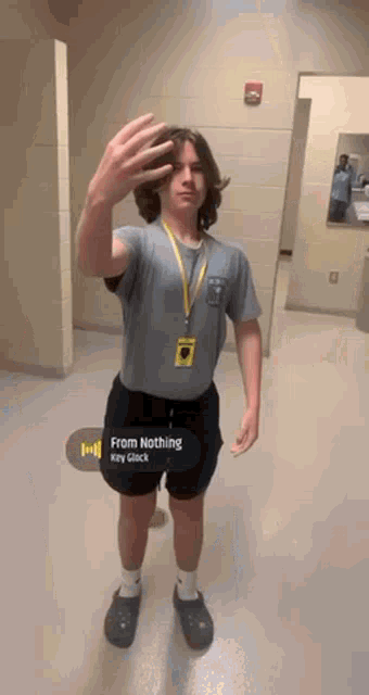 a young man is taking a picture of himself in a bathroom while listening to a song called from nothing .