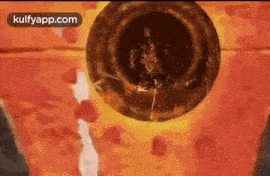 a person is standing in a circle of fire with a sword .