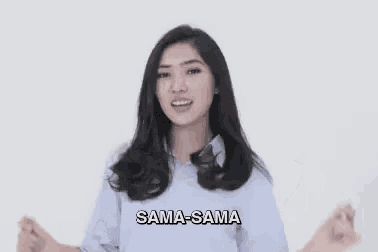 a woman is standing in front of a white wall with her arms outstretched and says sama-sama .