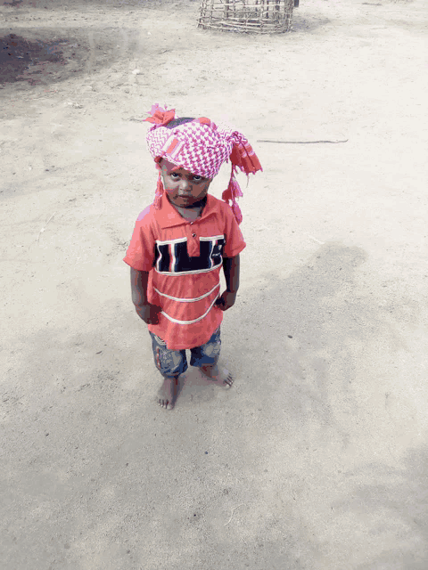 a little boy wearing a red shirt that says ' ii ' on it