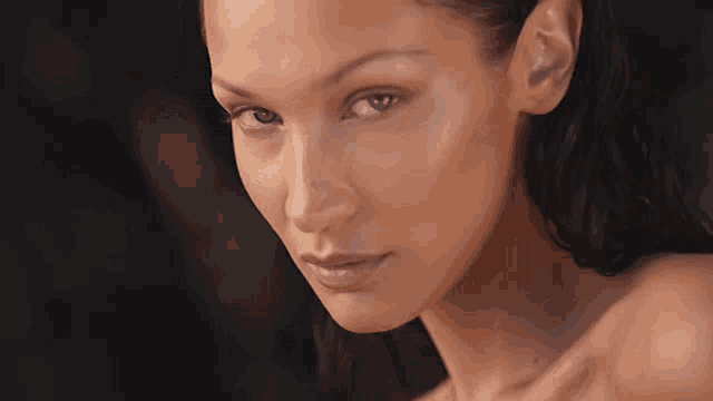 a close up of a woman 's face with her eyes closed